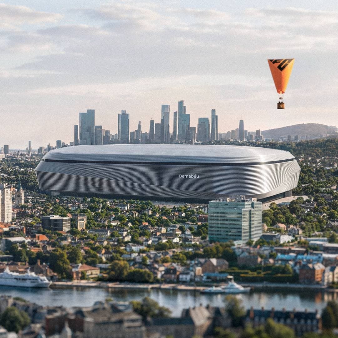 A famous stadium appears in a city skyline with an EA football hot air balloon.