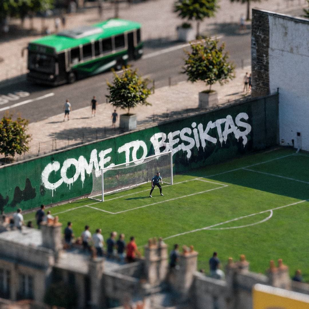 Goalkeeper on a small pitch under a giant 'COME TO BESIKTAS' graffiti mural.