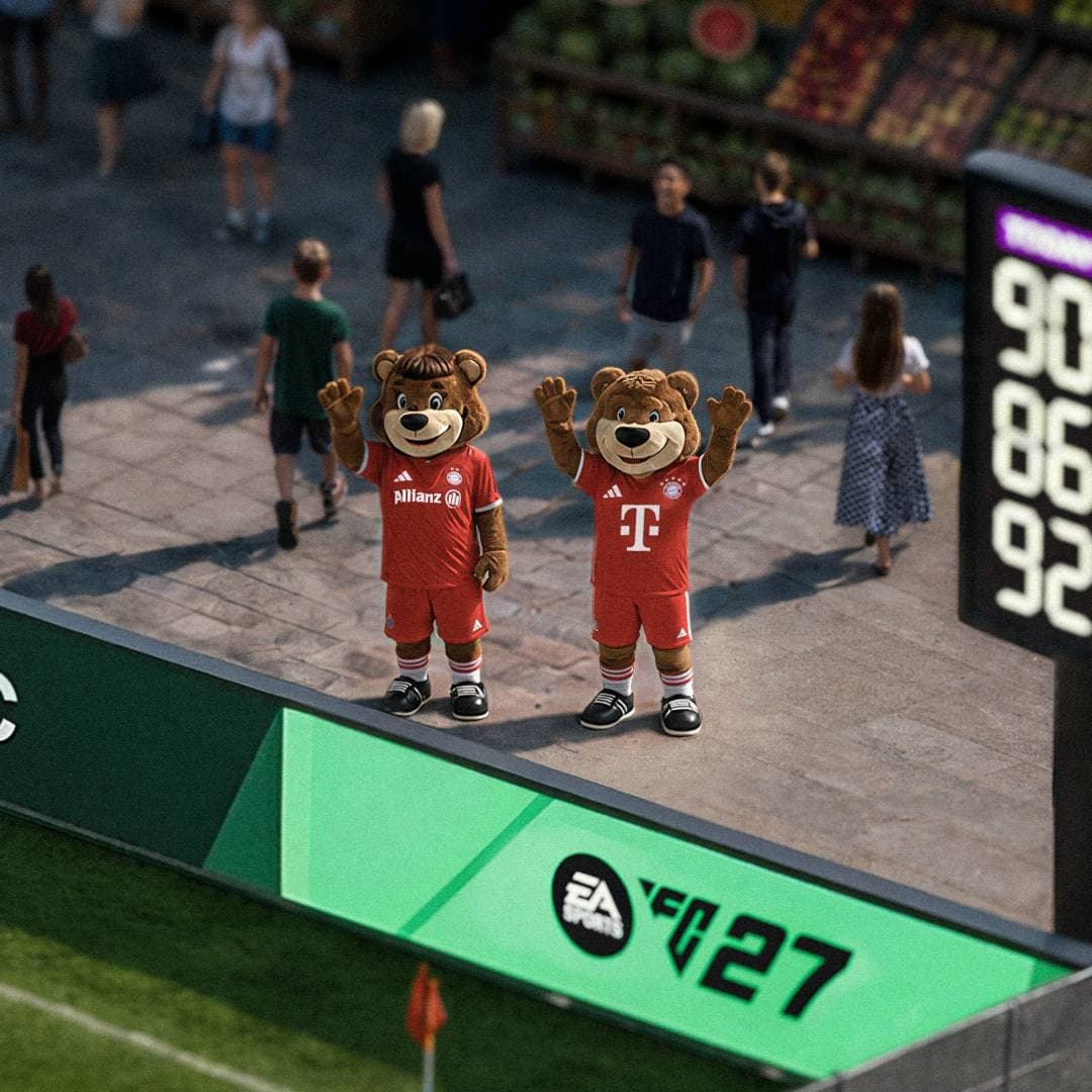 Two FC Bayern bear mascots in red kits waving beside the pitch.