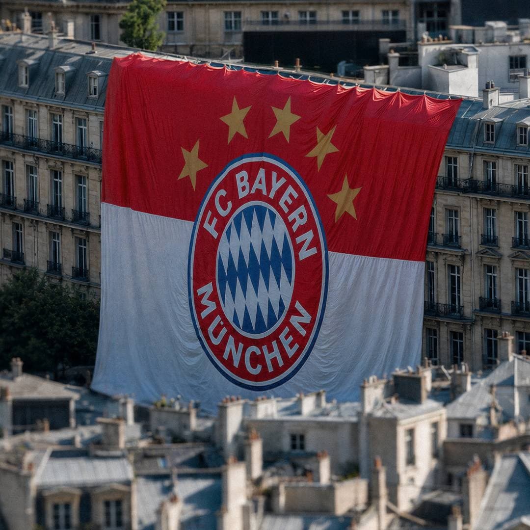 A giant FC Bayern Munchen banner with five stars draped over a building.